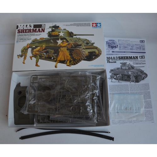 43 - Four unstarted plastic model kits, WWII/Vietnam War themed to include a 1/35 scale Tamiya M4A3 Sherm... 