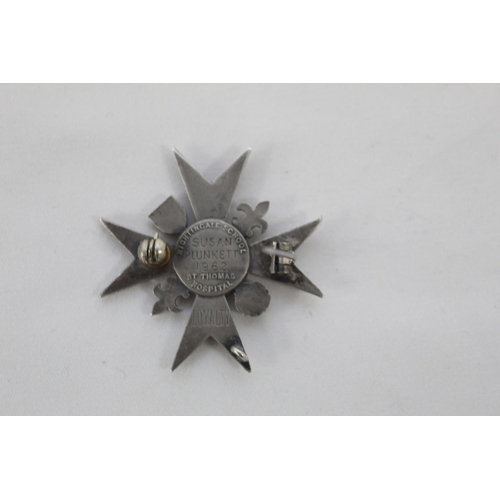 243 - Badge of the Florence Nightingale School of Nursing. In silver with blue enamel. Awarded to Susan Pl... 