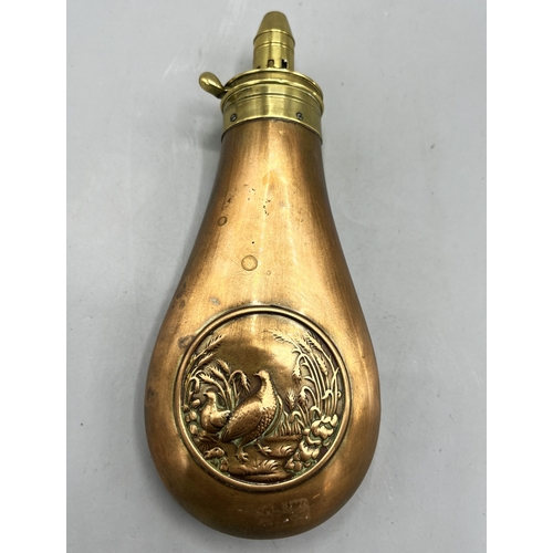 437B - Late 19th century powder flask, copper body relief decorated with Game birds, adjustable brass nozzl... 