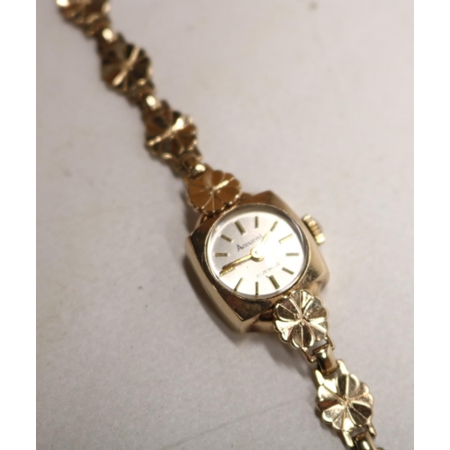 1010 - Accurist ladies 9ct gold wristwatch on integrated floral bracelet stamped .375, signed silvered sunb... 