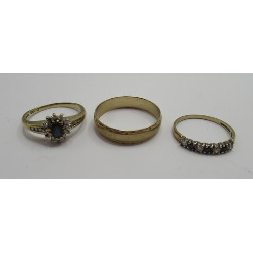 28 - 9ct yellow gold ring set with sapphire and clear stones, a 9ct gold band ring and a seven stone sapp... 