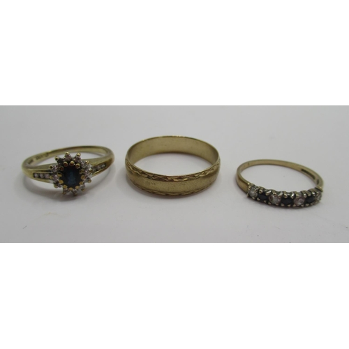 28 - 9ct yellow gold ring set with sapphire and clear stones, a 9ct gold band ring and a seven stone sapp... 