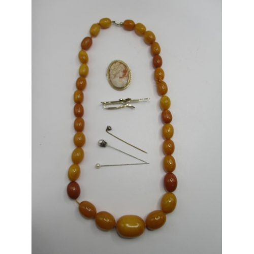 335 - Graduated butterscotch amber beaded necklace, 76.45g, a 9ct gold cameo brooch stamped 375, 5.58g, th... 