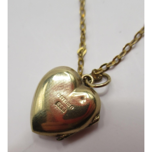 340 - 9ct yellow gold heart pendant with engraved foliage detail, stamped 375, on yellow metal chain with ... 