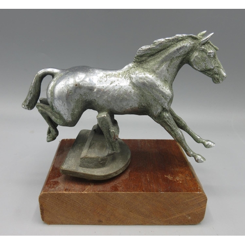 1265 - Chromed bronze car mascot hood ornament in the form of a horse leaping a fence, H11.5cm excl. mount