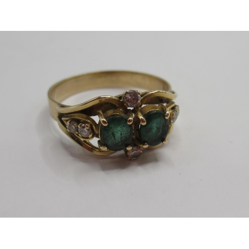 37 - Yellow metal ring set with two emeralds and six sapphires, unmarked, size O, 2.65g