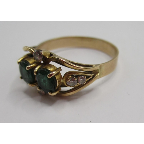 37 - Yellow metal ring set with two emeralds and six sapphires, unmarked, size O, 2.65g