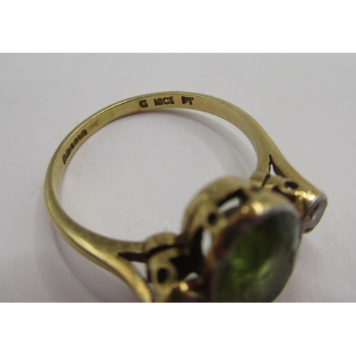 5 - 18ct yellow gold ring set with peridot flanked by diamonds, stamped 18ct, 3.9g