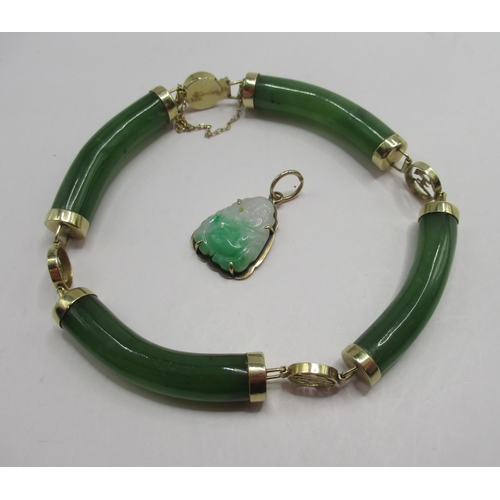 714 - 14ct yellow gold and carved jade bangle, stamped 14k, and an 18k yellow gold and carved jade buddha ... 