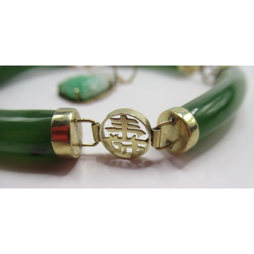 714 - 14ct yellow gold and carved jade bangle, stamped 14k, and an 18k yellow gold and carved jade buddha ... 