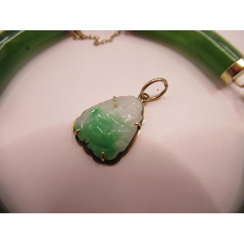 714 - 14ct yellow gold and carved jade bangle, stamped 14k, and an 18k yellow gold and carved jade buddha ... 