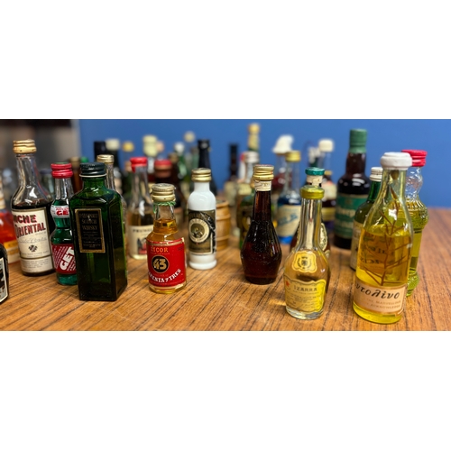 437 - A collection of 70 vintage miniatures from around the world, including Tequila, whisky, liquors etc.