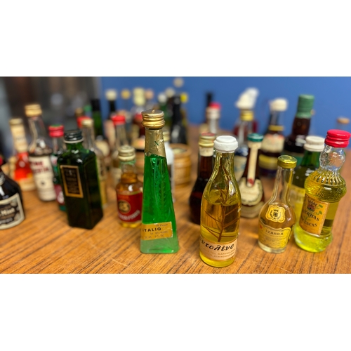 437 - A collection of 70 vintage miniatures from around the world, including Tequila, whisky, liquors etc.