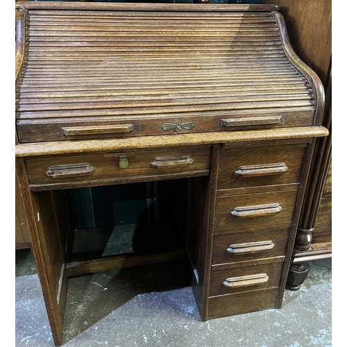 755 - 20th century oak single pedestal serpentine roll top desk, W91cm D66cm H109cm