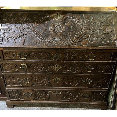 757 - Georgian oak bureau, fall front with fitted interior above four drawers on bracket feet, carved with... 