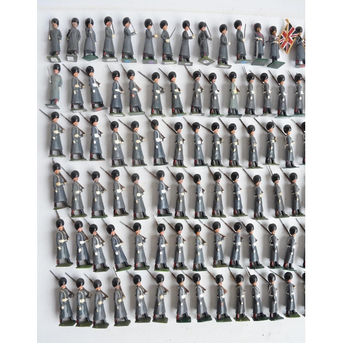 78 - Collection of metal Guardsmen model soldier figures in greatcoats to include W. Britain's, most/all ... 