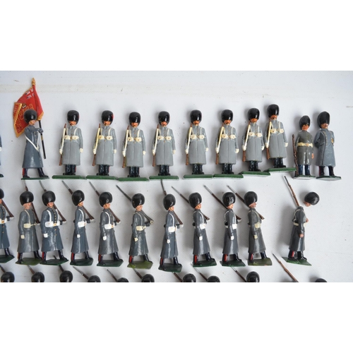 78 - Collection of metal Guardsmen model soldier figures in greatcoats to include W. Britain's, most/all ... 