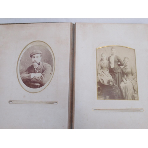  Three Victorian photograph albums containing period carte de visite portraits and cabinet cards