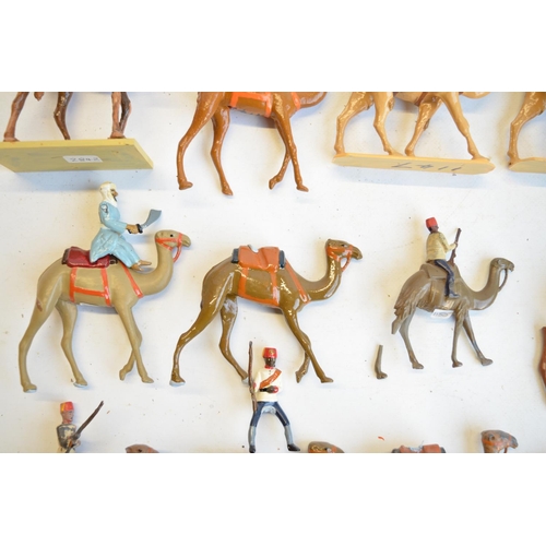 125 - Collection of competently home painted metal camels and camel riders plus 4 standing Arab soldiers o... 