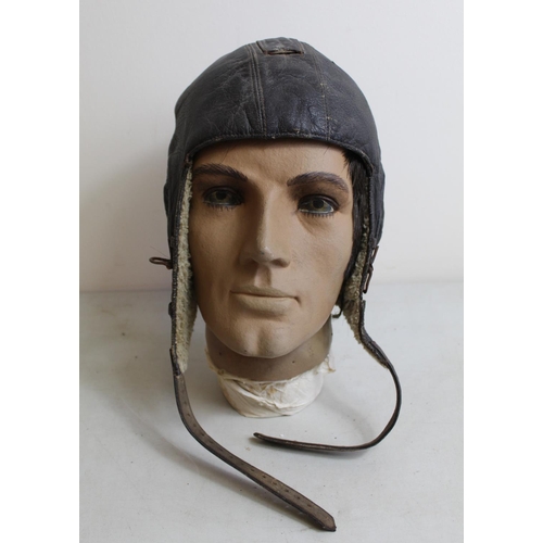 1456 - WWII Siemens LKpW101 Luftwaffe flying helmet with wool lining. Displayed on vintage realistic plasti... 