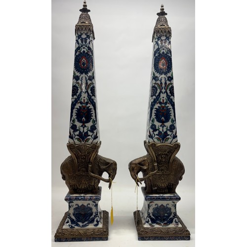 652 - Pair of Wong Lee ceramic obelisks with bronzed metal mount in the shape of an elephant, H61cm