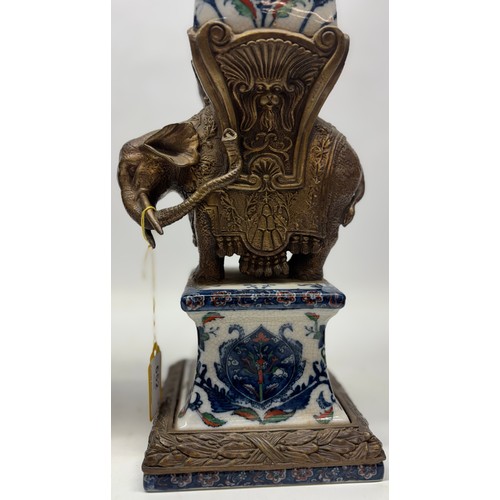 652 - Pair of Wong Lee ceramic obelisks with bronzed metal mount in the shape of an elephant, H61cm