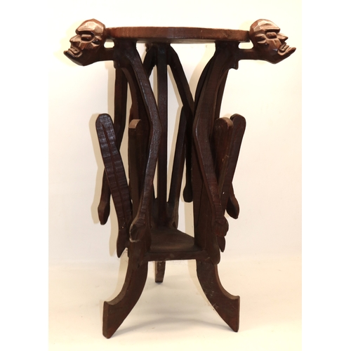 1281 - African carved wood side table, the supports modelled as grotesque figures, H72cm