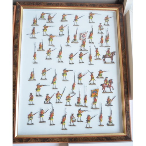 74 - Collection of thirteen framed hand painted alloy flat mostly soldier figures/figure sets to include ... 