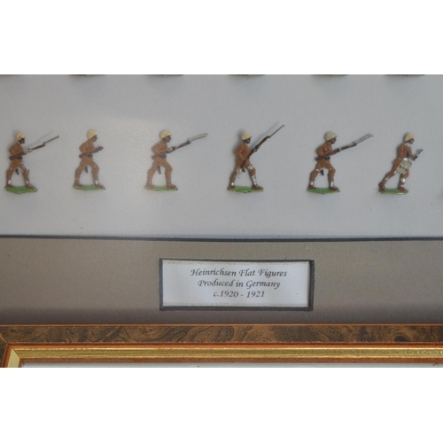 74 - Collection of thirteen framed hand painted alloy flat mostly soldier figures/figure sets to include ... 