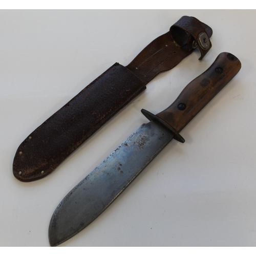 1438 - British military-issue survival knife with wooden handle and leather sheath. Wilkinson Sword stamp t... 