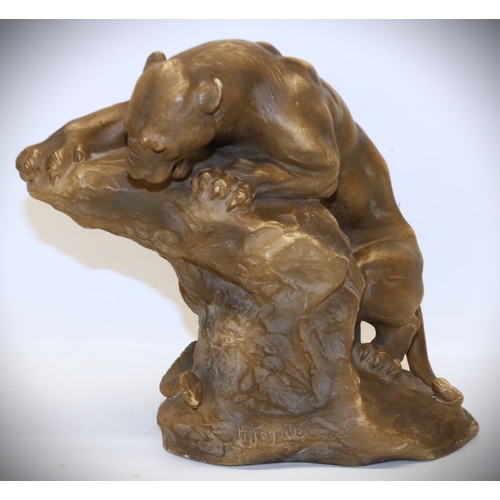 1278 - Armand Fagotto, early 20th century terracotta model of a lioness on a rock with snake, signed, H23.5... 