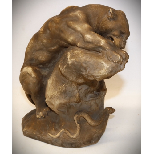 1278 - Armand Fagotto, early 20th century terracotta model of a lioness on a rock with snake, signed, H23.5... 