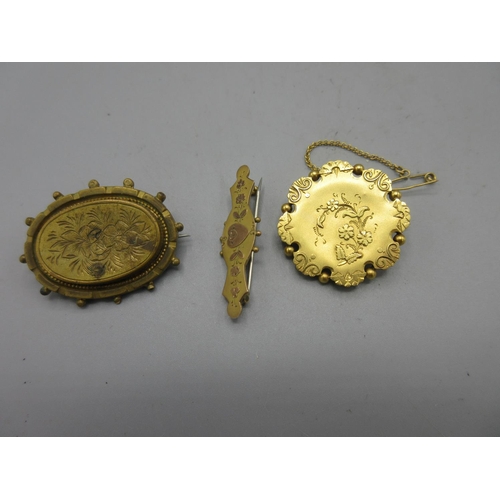 17 - Yellow metal mourning brooch with floral detail, with clear panel to back, stamp worn, a similar 9ct... 