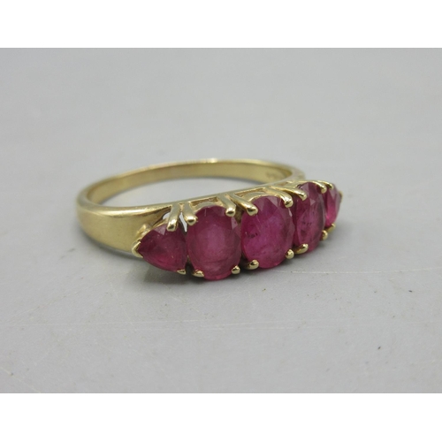 302 - 14ct yellow gold ring set with five rubies, stamped 585, 3.7g