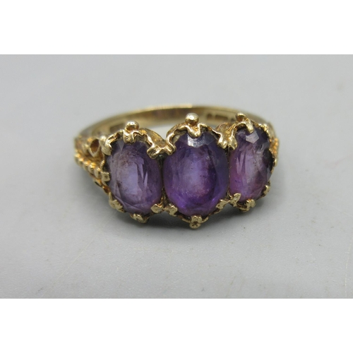 35 - 9ct yellow gold ring set with three purple stones in an ornate mount, a 9ct yellow gold band ring, a... 