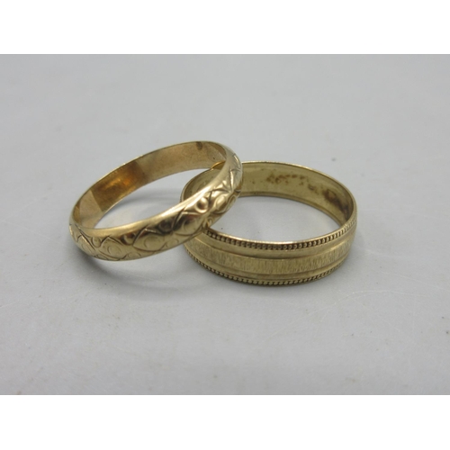 795 - 9ct yellow gold band ring with engraved border detail, and a wedding band with waved engraved design... 