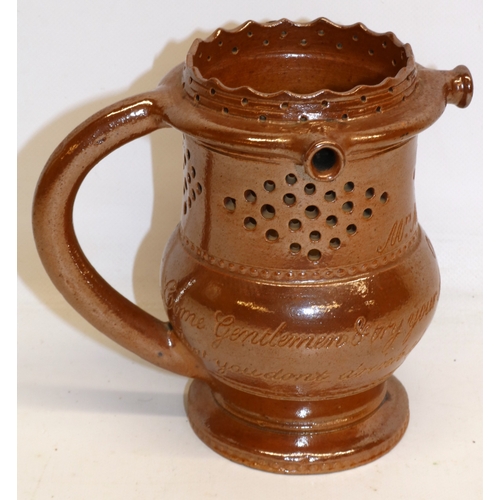 313 - Brown salt-glazed puzzle jug, inscribed 'Mrs. M Powell Oct 25, Come Gentlemen and try your skill, I'... 