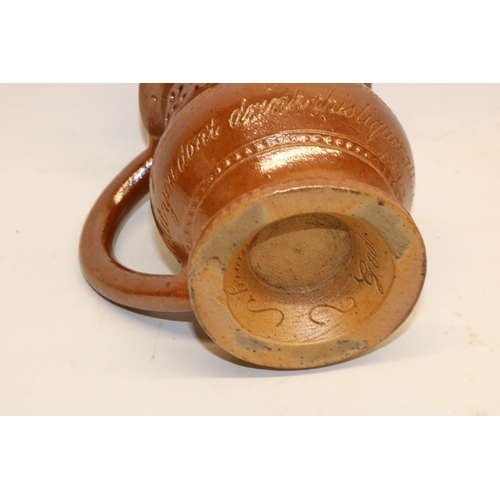 313 - Brown salt-glazed puzzle jug, inscribed 'Mrs. M Powell Oct 25, Come Gentlemen and try your skill, I'... 