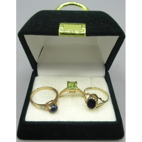 166 - 9ct yellow gold ring set with a deep blue cabochon sapphire with white sapphires set on the band eit... 