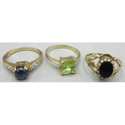 166 - 9ct yellow gold ring set with a deep blue cabochon sapphire with white sapphires set on the band eit... 