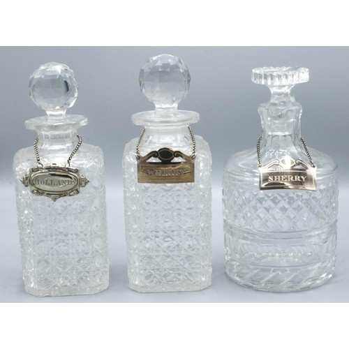 730 - Two hobnail decorated lead crystal decanters, similar jug with prismatic stoppers, with EPNS labels ... 