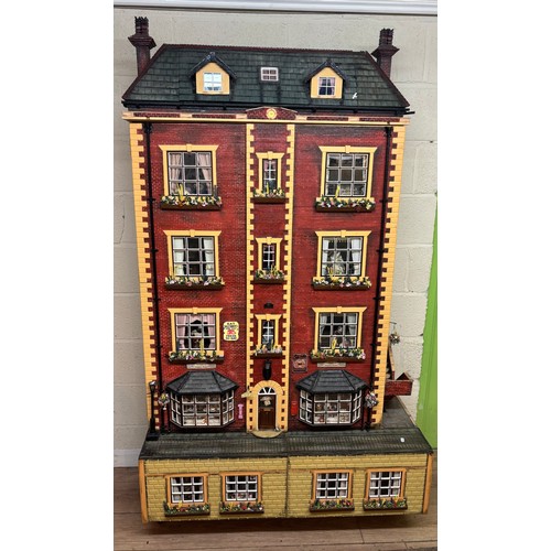 809 - Large late 20th century town house style dolls house, extensively furnished and with a quantity of d...