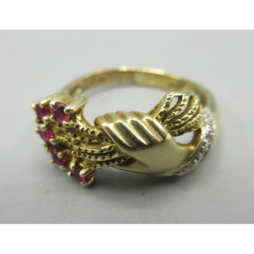 49 - 14ct yellow gold ring with hand and bouquet detail set with rubies and diamonds, stamped 14k, 4.9g