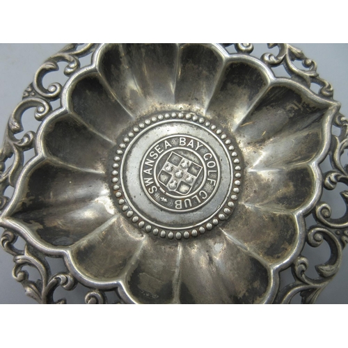 722 - Edwardian silver pin dish with pierced scrolling boarder and central coin for the Swansea Bay Golf C... 