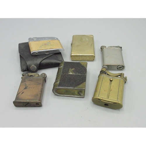 683 - Brass Zippo lighter and four other similar petrol lighters