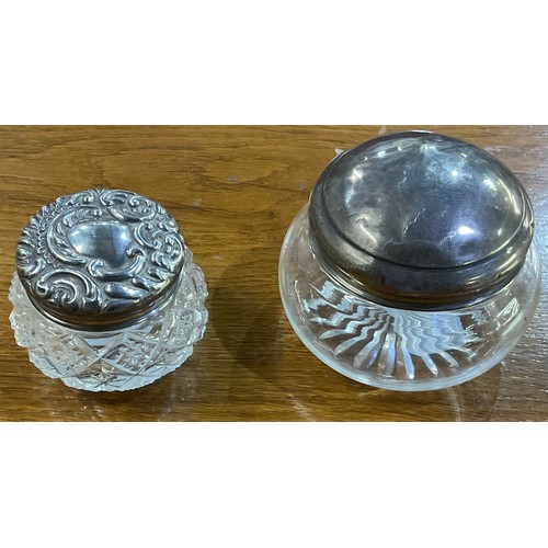 181 - Geo. V embossed silver top glass dressing table jar, Birmingham 1904, and another with plain top, Bi... 