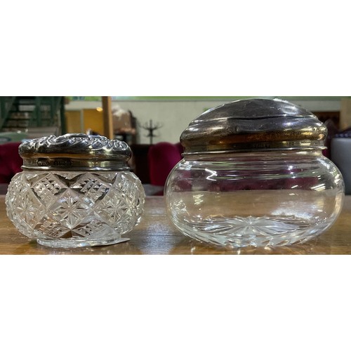 181 - Geo. V embossed silver top glass dressing table jar, Birmingham 1904, and another with plain top, Bi... 