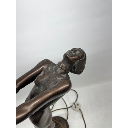 669 - Art Deco style lamp in the shape of a female holding a spherical glass shade, H56.5cm