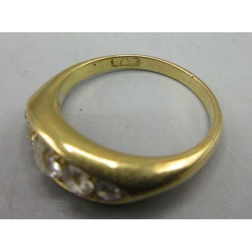 9 - Yellow metal ring set with five diamonds in rub over setting, size J, no hallmark, 3.5g