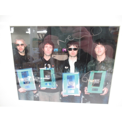 335 - Oasis - framed photograph signed by all four members with COA from TNM-Autographs, 42.4cm x 32.4cm &... 